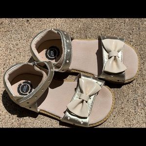 Livie & Luca gold sandals with cream bow